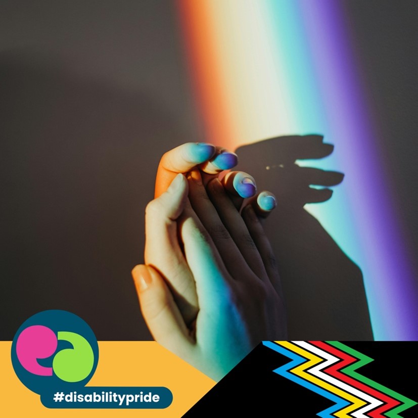 hands holding with a rainbow reflection on them