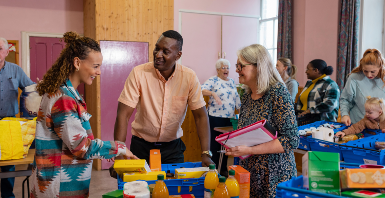 People at a food bank helping with surplus food and donations