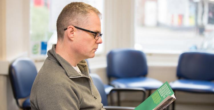 Man reading pamphlet