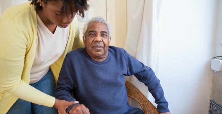 Woman caring for an elderly person