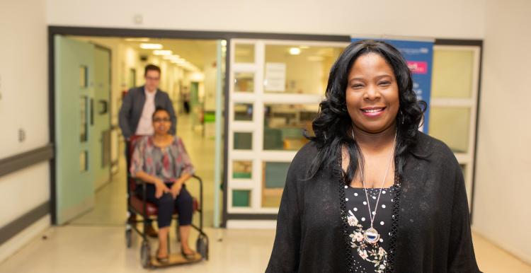 Woman standing in hospital corridor