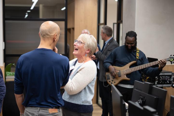 Attendees at Healthwatch Wandsworth Assembly with band Assorted Beat playing in the background