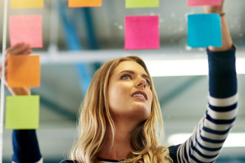 Woman deciding between post it notes