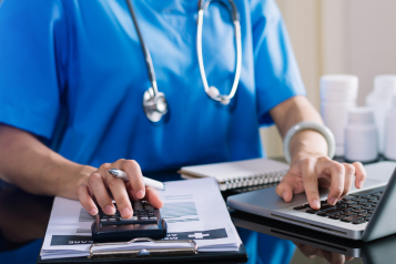 Doctor in uniform on the laptop