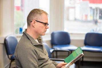 Man reading pamphlet