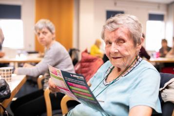 Lady reading Healthwatch flyer