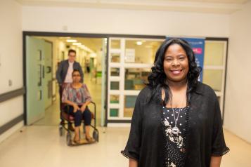 Woman standing in hospital corridor