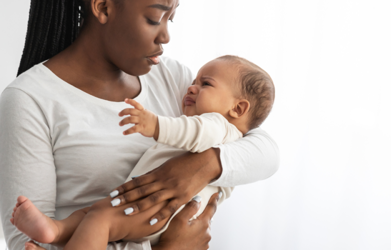 woman holding baby, both look distressed