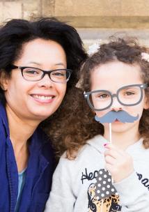 Woman and girl with paper moustache
